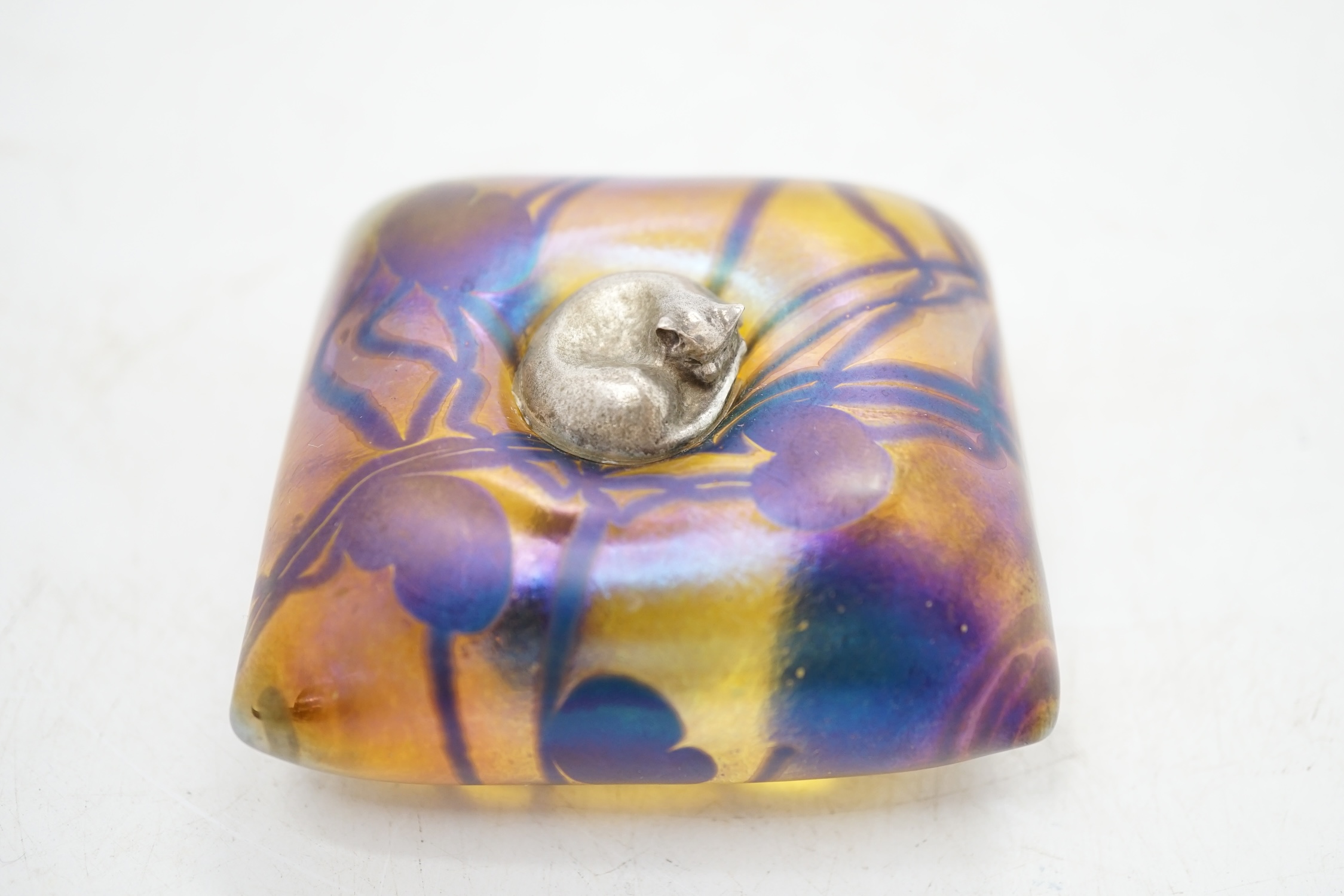A John Ditchfield for Glasform paperweight modelled as a metal cat sitting on a cushion, 6.5cm square. Condition - fair